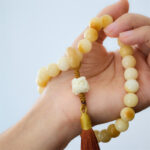 Buddha Stones Natural Bodhi Seed Ivory Fruit Dancing Lion Charm Harmony Tassel Wrist Mala Wrist Mala BS 1