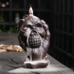 Buddha Stones Halloween Skull With Ghost Hand Purple Clay Spiritual Incense Burner Decoration Incense Burner BS Halloween Skull With Ghost Hand 9.6*11.2*15.5cm