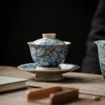 Buddha Stones Vintage Blue And White Porcelain Peach Blossom Lotus Peony Ceramic Gaiwan Sancai Teacup Kung Fu Tea Cup And Saucer With Lid Cup BS 9.3cm*9.8cm*150ml(Saucer 13.3cm)
